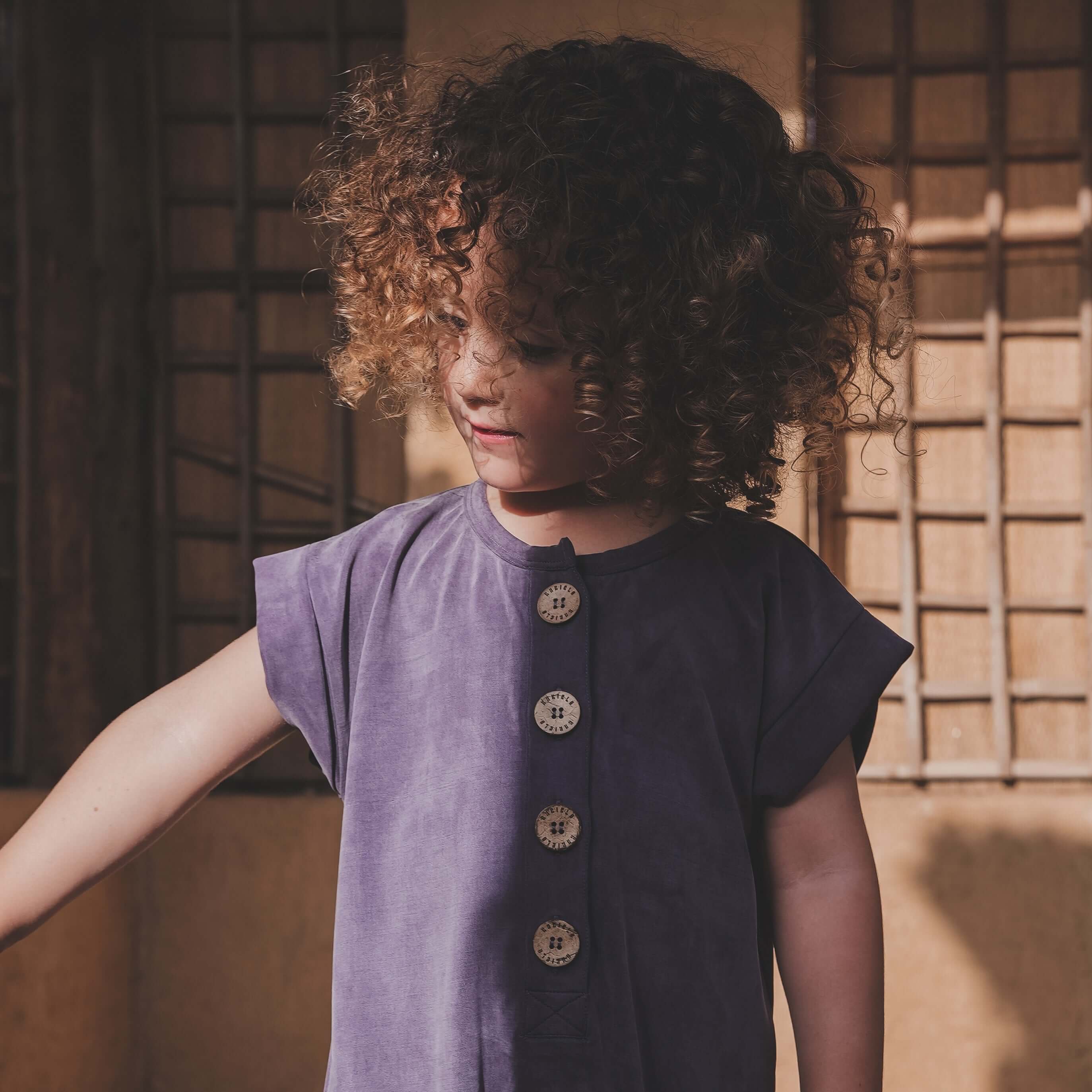 BABICLO Best Sellers for Babies and Kids - Child holding a camera on a boat with sunglasses and blue clothing.