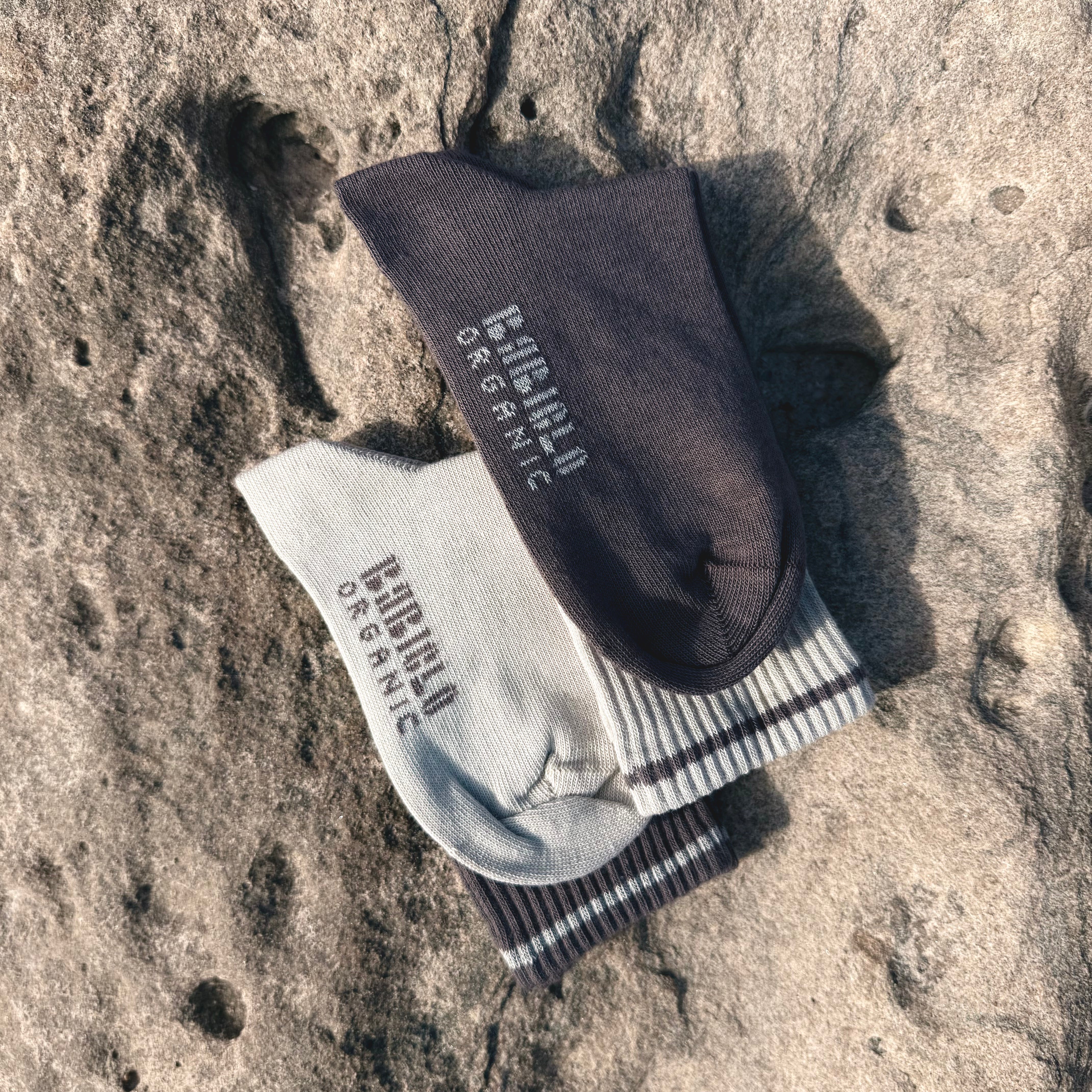 BABICLO premium organic cotton socks, showcasing a pair of sustainable socks on a textured surface.